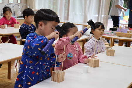 ハンマーで木の棒を奥まで押し込みます
